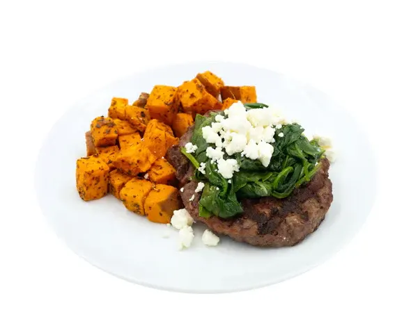 High protein foods including meat, fish, eggs, dairy and legumes arranged on a table